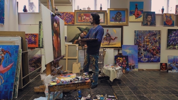 The Artist Paints With Oil Painting. In The Studio, Among His Own Works. 