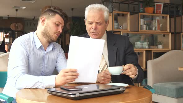 Business Partners Discuss Some Papers