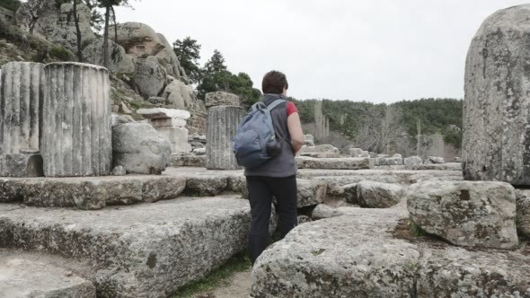 Woman Takes a Picture Among Ruins