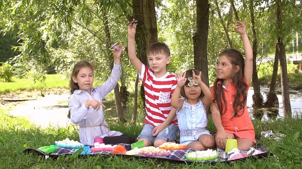 Four Children Having Fun in the Park. Slow Motion