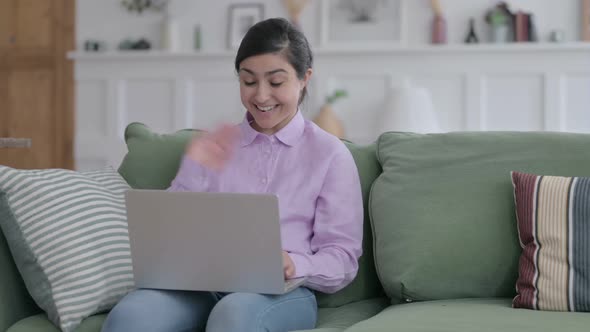 Indian Woman Talking on Video Call on Laptop on Sofa