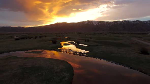 Flying over river as the sunrises