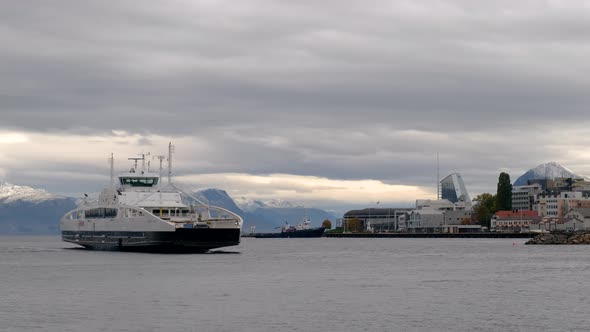 Ferry Arriving Molde Harbour On A Cloudy Day With Mountains View In The Background, Norway. - Aerial