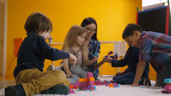 Carefree Preschool Children Relaxing in Playroom