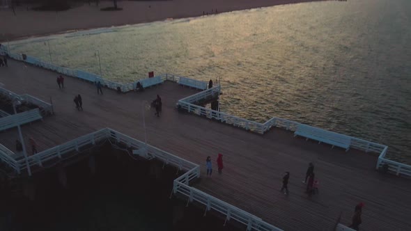 Cinematic pier in the sunset from a bird's eye view. Filming at sunset in Sopot.