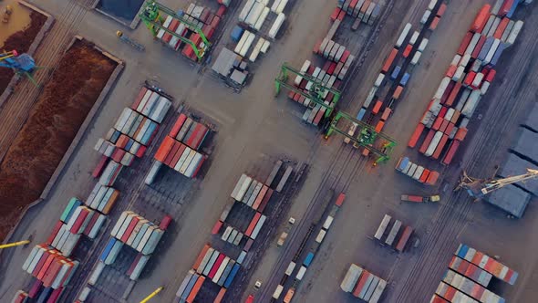 Aerial View From a Rotating Drone of the Cargo Area of the Port with Containers Bulk Cargo Cranes