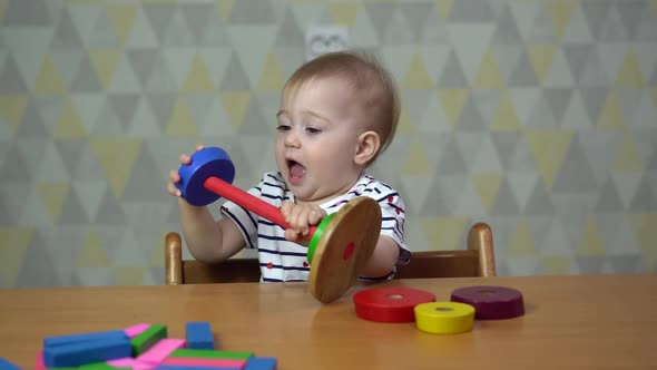 a Little Girl Plays Sitting at a Table