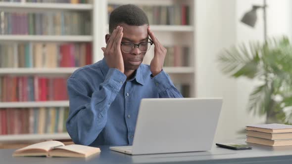 Young African Man Having Headache While Working on Laptop