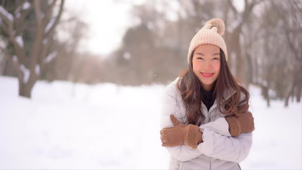 Young asian woman enjoy smile around snow and winter