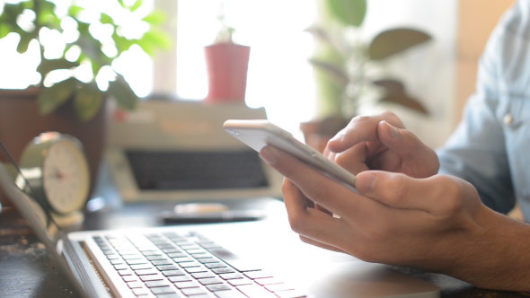 Man Working Online and  Using Smartphone alt