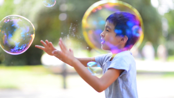 Boy Catching Soap Bubbles