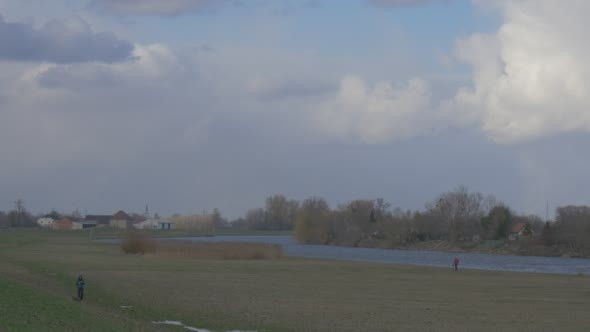 Woman is Walking With a Black Small Dog Man