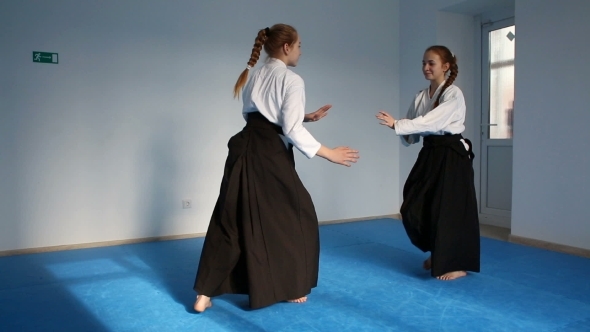 Two Girls In Black Hakama Practice Aikido