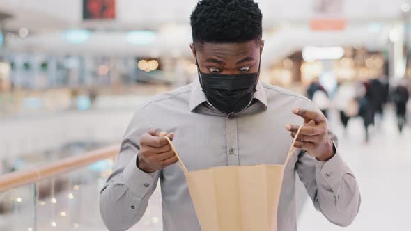 Closeup Young African American Man in Protective Medical Mask Standing in Mall Male Client Buyer