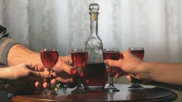 Four Friends Hold Glasses With Cranberry Tincture