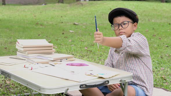 Boy drawing and water coloring