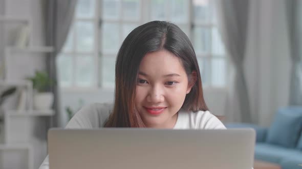 Close Up Asian Girl Typing On Computer Keyboard Of A Laptop And Smiling At Home