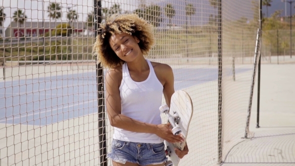 Smiling Young Black Woman With Skateboard