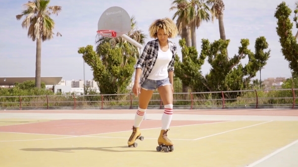 Woman In Roller Skates On Basketball Court