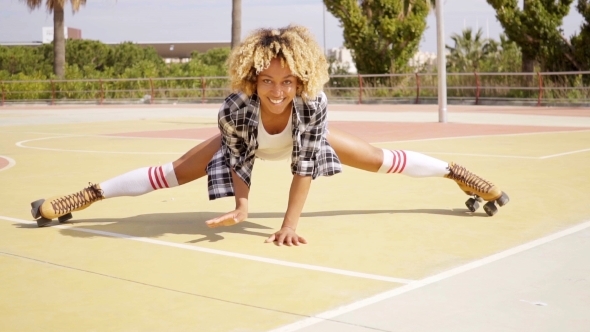 Fun Young Woman Doing The Splits On Skates