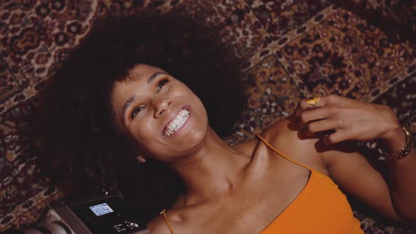 Woman With Afro Hair Smiling With Vintage 8Mm Camera