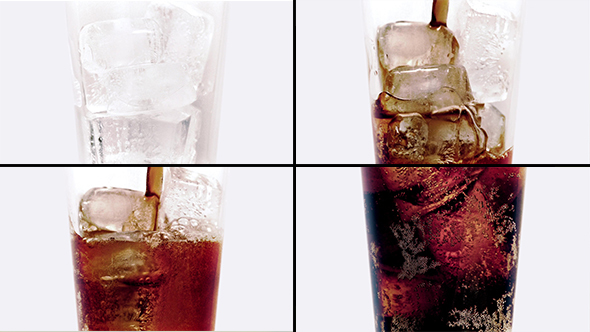 Coke Poured Over Ice Cubes In Glass