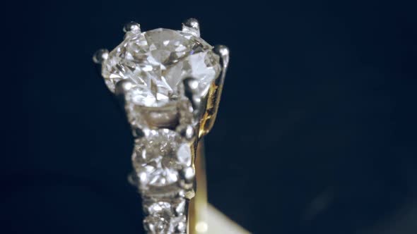 Extreme detailed of diamond ring close up shot while rotating on dark background