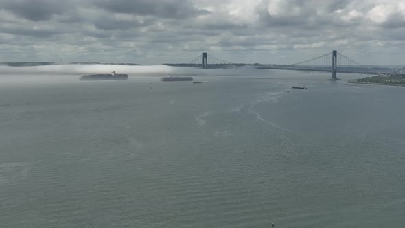 An aerial view of Gravesend Bay in Brooklyn, NY on a cloudy day. A dense fog is on the horizon over