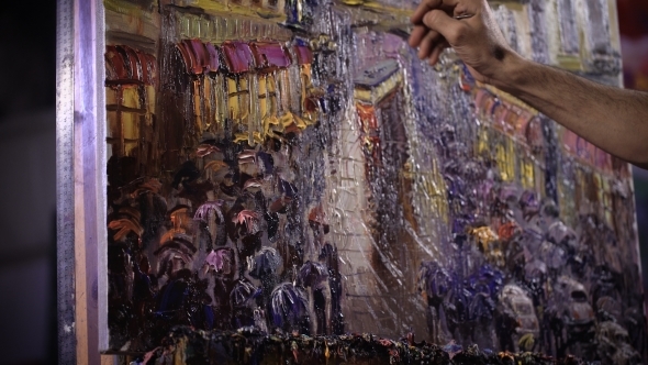 An Artist Painting With a Palette Knife In Studio