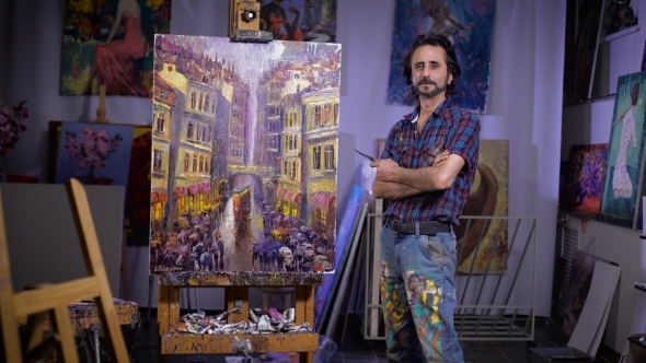 Victory. Professional Artist Stands Next To His New Picture. He Looks Into The Camera.  alt