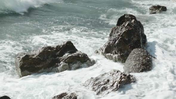 Close-Up of Storm Surf With Black Rocks