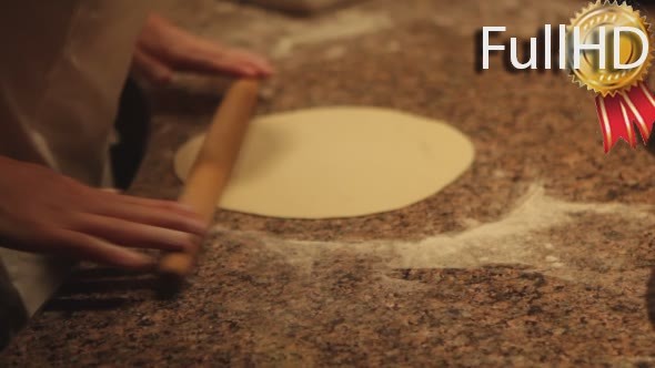 Man Makes Pizza Dough Rolls