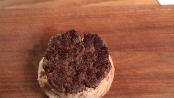 Closeup View of a Professional Chef Preparing Delicious and Juicy Burgers at a Fast Food Restaurant