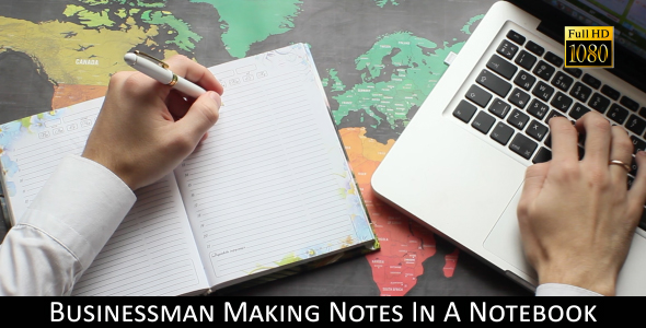 Businessman Making Notes In A Notebook