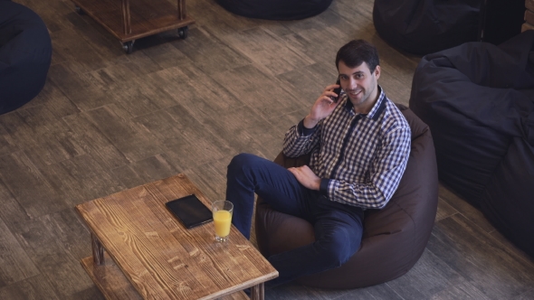 A Man In a Shirt Talking On The Phone.