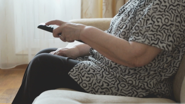 Old Woman Holding a Remote Control