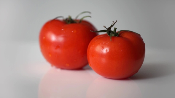 Two Fresh Tomatoes Rotation On White Backround