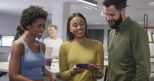 Portrait of happy diverse male and female business colleagues discussing