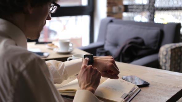 Businessman Using Smart Watches alt