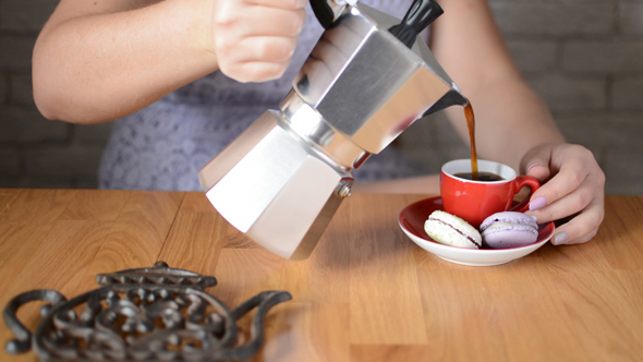 Woman Pouring Coffee from Italian Moka Pot