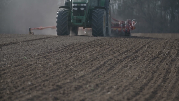 Tractor Plowing Field At Sunset