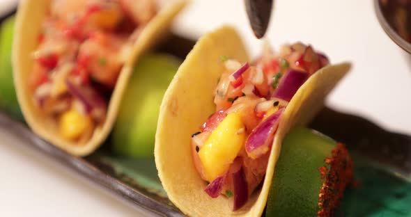 Chef Putting Seasoned Fillings On The Crispy Taco Shell - Sushi Tacos.  - close up shot