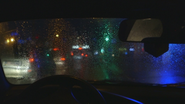 Night City Traffic Through Wet Window