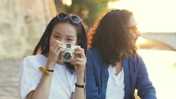 Couple taking photos at sunset in Paris France