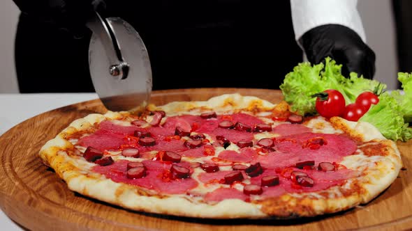 Chef Slicing Pizza Pieces