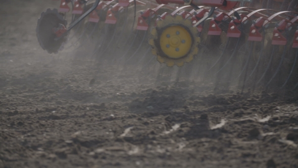 Tractor Plowing Field At Sunset