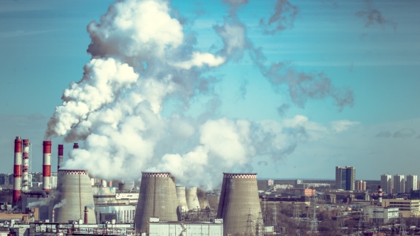 Coal Fired Power Station With Cooling Towers Releasing Steam Into Atmosphere.