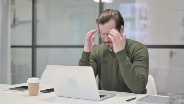 Young Businessman Having Headache While Working on Laptop