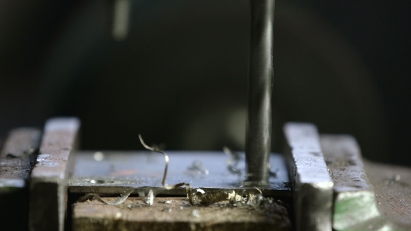 Drilling Machine Making a Hole In a Steel Bar