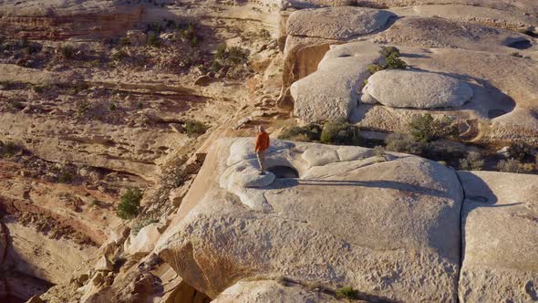 Aerial shot of a hiker at the the edge of Cedar Mesa in Utah